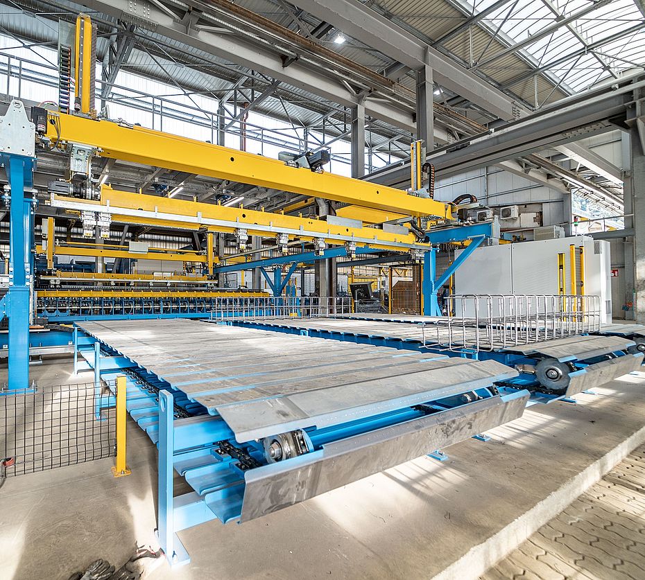 Automated production line with cross conveyor and stacked precast element slabs in concrete plant